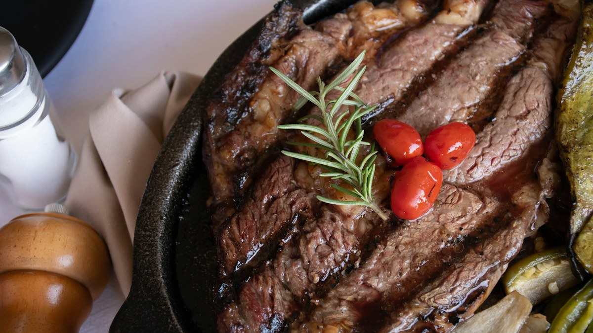 Grilled steak meal used to illustrate location-based menu price comparisons
