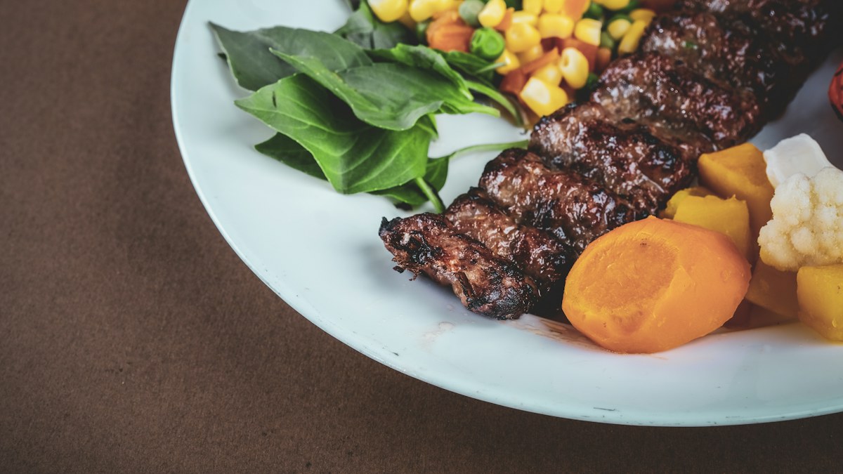 Grilled steak with vegetables for comparing steakhouse meal portions