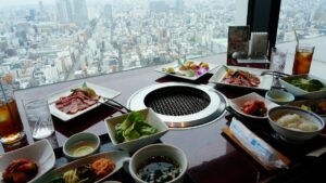 Restaurant meal with city view representing menu price differences by location