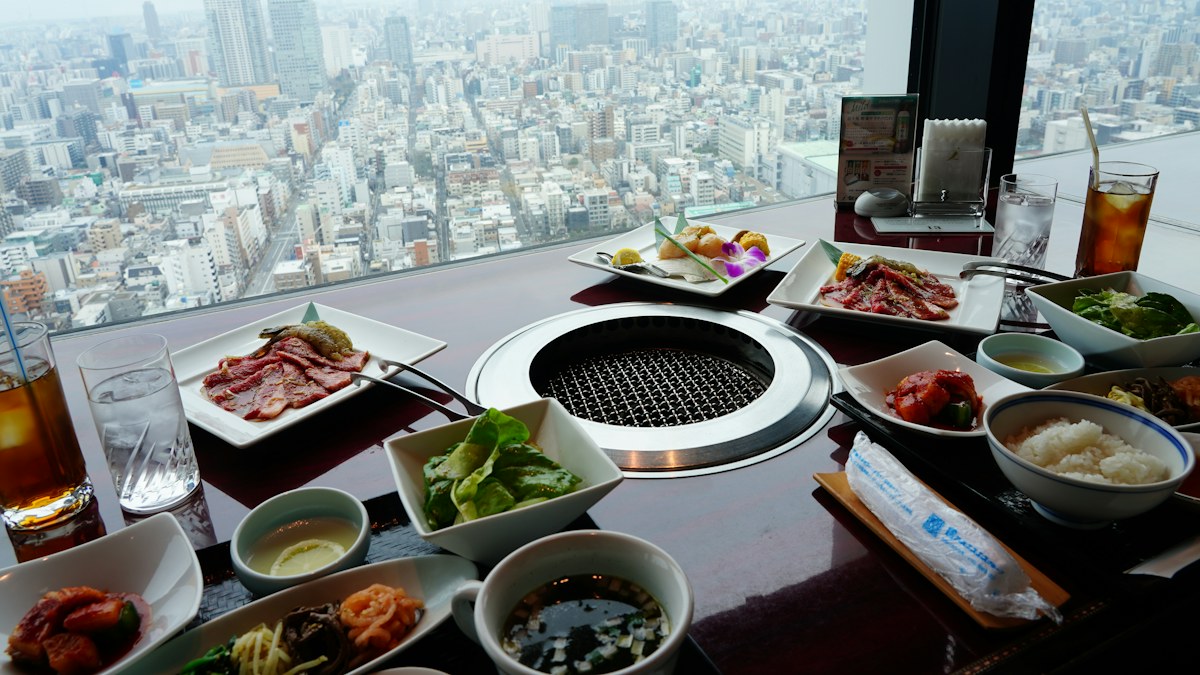 Restaurant meal with city view representing menu price differences by location